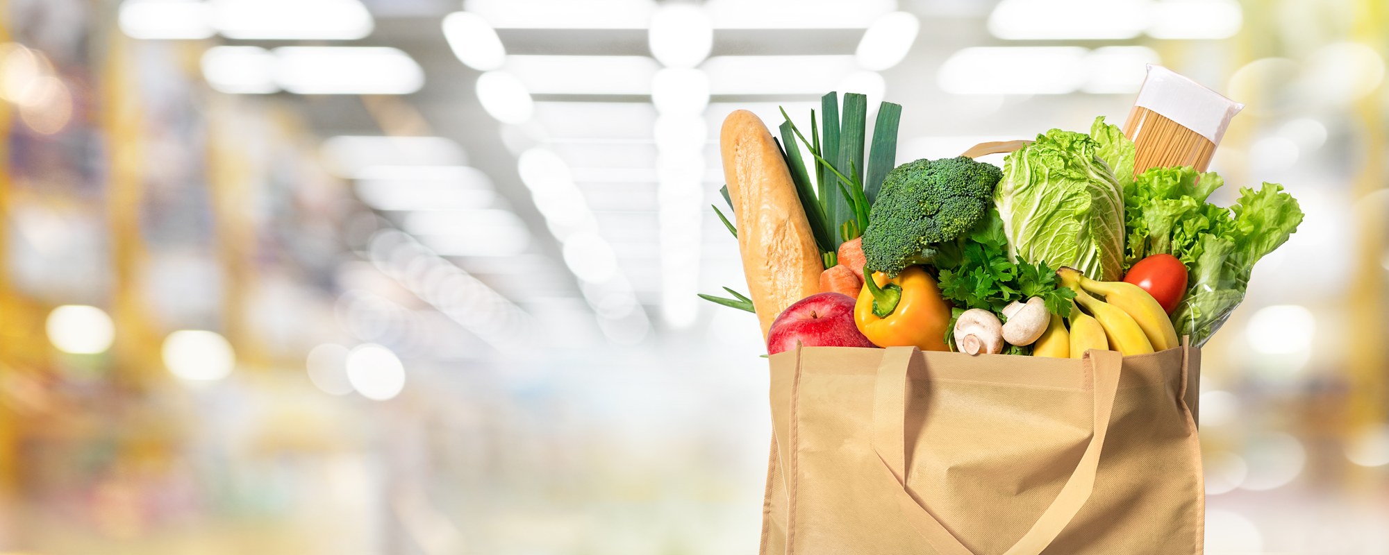 Paper bag full of fresh produce in supermarket